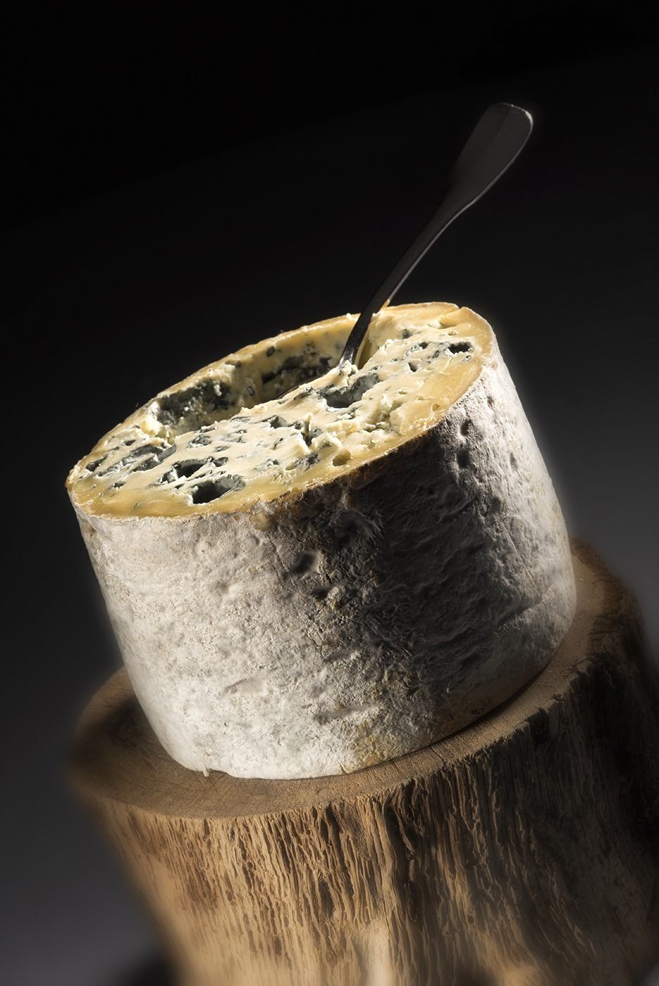 Fourme entamée, une cuillère plantée dans la pâte